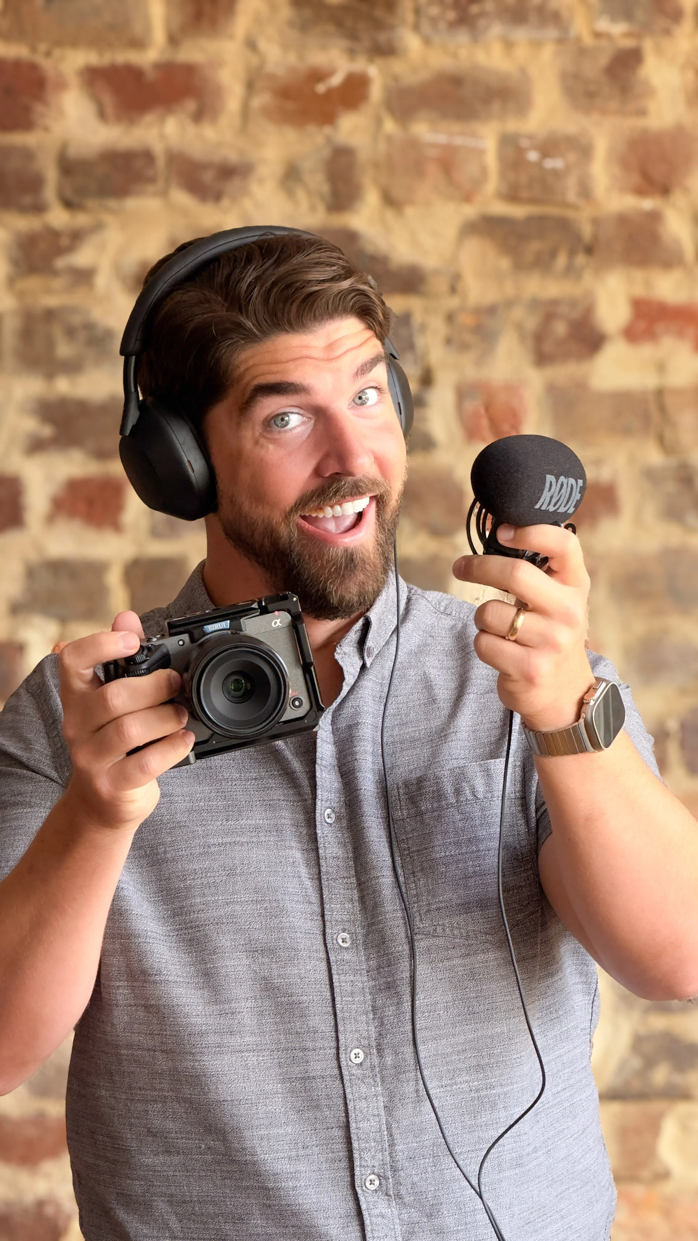 Mark Harvey, Owner and Creative Director of Origin Socials, holding a Sony camera and RODE microphone